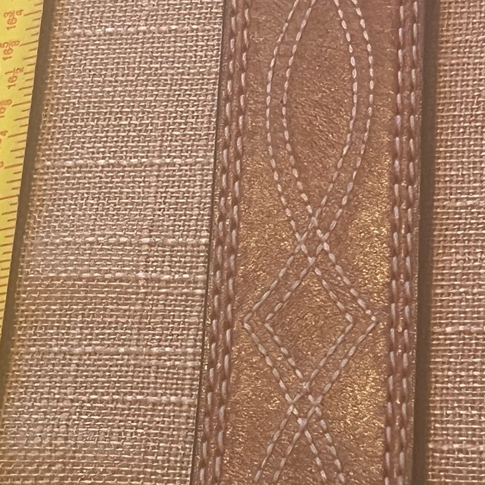 Brown leather belt with large red enamel buckle